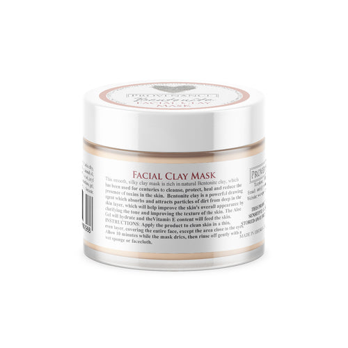 Facial clay mask in small clear glass jar with white screw-top lid.