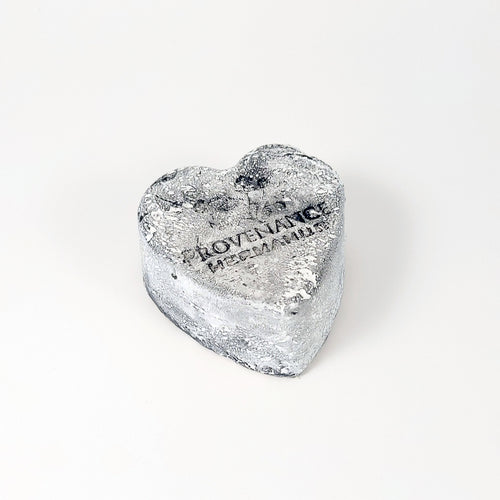 Handmade charcoal, heart-shaped soap bar with light coating of white powder.