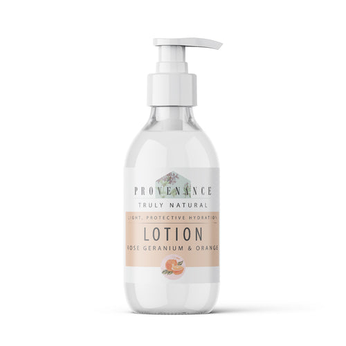 Lotion in clear glass bottle with pump.